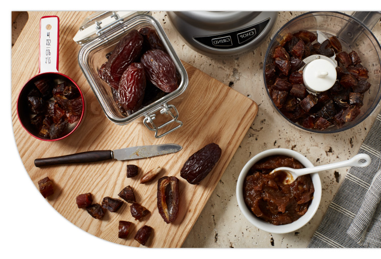 Medjool dates on a cutting board making paste